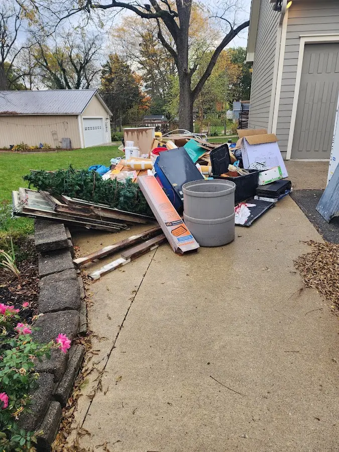 Dumpster being loaded with debris for Estate Cleanout Dumpster Rental in Gaines